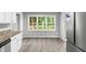 Bright kitchen with white cabinets and large windows to the outdoor deck at 2487 Highland Se Dr, Conyers, GA 30013