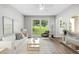 Cozy living room with plush seating, a large window overlooking the yard, and stylish decor at 2487 Highland Se Dr, Conyers, GA 30013