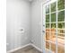 Bright mud room with a white door that leads to an outdoor wood deck and tree views at 2487 Highland Se Dr, Conyers, GA 30013