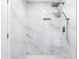 Modern tiled shower featuring marble-look walls, rainfall shower head, and a built-in niche at 2487 Highland Se Dr, Conyers, GA 30013