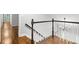Staircase leading to the second floor, featuring hardwood floors and white painted railings at 2487 Highland Se Dr, Conyers, GA 30013