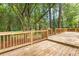 Wide open wooden deck area surrounded by a wooden fence and tall trees at 2487 Highland Se Dr, Conyers, GA 30013