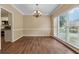 Clean dining room with wood floors, neutral paint, light fixture, and lots of light at 3355 Golfe Links Dr, Snellville, GA 30039