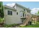 Two story home's backyard with deck, stairway, and ample green space at 3355 Golfe Links Dr, Snellville, GA 30039