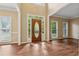 Bright foyer featuring hardwood floors, a decorative front door, and natural light from many windows at 3355 Golfe Links Dr, Snellville, GA 30039