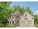 Charming two-story home with stone and stucco exterior and a well-manicured lawn at 3355 Golfe Links Dr, Snellville, GA 30039