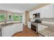 Modern kitchen with stainless steel appliances, granite countertops, and white cabinets at 3355 Golfe Links Dr, Snellville, GA 30039