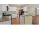 Open kitchen featuring granite countertops, stainless steel appliances, and a breakfast bar at 3355 Golfe Links Dr, Snellville, GA 30039