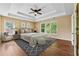 Comfortable main bedroom features a tray ceiling, fan, and large windows at 3355 Golfe Links Dr, Snellville, GA 30039