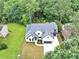 Aerial view of a stunning two-story house with a manicured lawn and a dark gray roof at 3562 Clubland Dr, Marietta, GA 30068