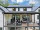 Spacious outdoor living space with covered patio, fireplace, dining table, and backyard at 3562 Clubland Dr, Marietta, GA 30068