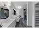 Bathroom featuring a walk-in closet, glass shower, a soaking tub, and white vanity with a round mirror at 3562 Clubland Dr, Marietta, GA 30068