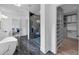 Bathroom featuring a soaking tub, a walk-in shower, and access to a walk-in closet at 3562 Clubland Dr, Marietta, GA 30068