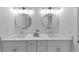 Bright bathroom features double sink vanity with gold fixtures, quartz countertop, and round mirrors at 3562 Clubland Dr, Marietta, GA 30068