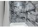 Beautiful bathroom featuring decorative marble tile, modern fixtures, and a luxurious bathtub at 3562 Clubland Dr, Marietta, GA 30068