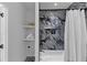 Elegant bathroom with decorative tiles, tub, and shelving at 3562 Clubland Dr, Marietta, GA 30068