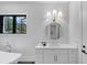 Bathroom with marble floors, white vanity, gold fixtures, soaking tub and black frame windows at 3562 Clubland Dr, Marietta, GA 30068