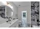 Modern bathroom featuring marble tile, round mirror, and white vanity at 3562 Clubland Dr, Marietta, GA 30068