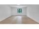 Minimalist bedroom with hardwood floors, recessed lighting, and a large window with natural light at 3562 Clubland Dr, Marietta, GA 30068