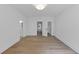 Bright bedroom with wood flooring, open closet, and doorways to bathroom and hall at 3562 Clubland Dr, Marietta, GA 30068