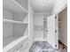 Spacious walk-in closet with custom shelving, drawers and a door leading to another room at 3562 Clubland Dr, Marietta, GA 30068