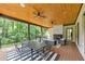 Outdoor dining and living area on the spacious covered patio with a fireplace at 3562 Clubland Dr, Marietta, GA 30068
