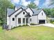 Elegant two-story home featuring a manicured lawn and a modern, painted brick exterior at 3562 Clubland Dr, Marietta, GA 30068