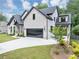 Stunning white brick home featuring a spacious driveway, lush landscaping, and a dark roof at 3562 Clubland Dr, Marietta, GA 30068