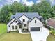 Beautiful white brick home featuring black trim, a dark roof, and a spacious driveway at 3562 Clubland Dr, Marietta, GA 30068