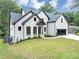 Beautiful white brick home featuring black trim, a dark roof, and a spacious driveway at 3562 Clubland Dr, Marietta, GA 30068