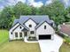 Stunning two-story home with a black trim and a manicured lawn, offering modern elegance at 3562 Clubland Dr, Marietta, GA 30068