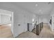The upstairs hallway showcases light wood floors and a modern staircase at 3562 Clubland Dr, Marietta, GA 30068