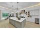 A modern, spacious kitchen with gray island, stainless steel appliances, and decorative lighting at 3562 Clubland Dr, Marietta, GA 30068