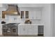 Close-up of the kitchen features stainless steel appliances, quartz countertops, and custom cabinetry at 3562 Clubland Dr, Marietta, GA 30068