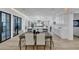 Open-concept kitchen featuring white cabinets, stainless steel appliances, and a large dining table at 3562 Clubland Dr, Marietta, GA 30068