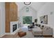 Light-filled living room with a fireplace, large windows, and modern decor at 3562 Clubland Dr, Marietta, GA 30068
