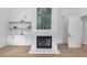 Bright living room with fireplace, custom shelving and cabinets, and light wood flooring at 3562 Clubland Dr, Marietta, GA 30068