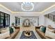 Open-concept living room showcasing modern furnishings, neutral tones, hardwood floors, and an open flow to the kitchen at 3562 Clubland Dr, Marietta, GA 30068