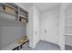 Bright mudroom with gray millwork, open shelves, seating and tile floors at 3562 Clubland Dr, Marietta, GA 30068