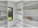 Bright pantry features ample shelving, a window, and crisp white paint at 3562 Clubland Dr, Marietta, GA 30068