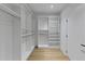 Bright and organized walk-in closet with custom shelving, rod and wood floors at 3562 Clubland Dr, Marietta, GA 30068