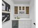 This wet bar features white cabinetry, wine storage, marble counters, and under-counter refrigerator at 3562 Clubland Dr, Marietta, GA 30068
