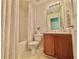 Bright bathroom with a shower-tub combo, wood vanity, and neutral-toned walls and tile at 105 Avonwood Cir, Locust Grove, GA 30248