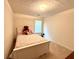 Cozy bedroom with white wooden bed frame, neutral walls and carpet, and natural light at 105 Avonwood Cir, Locust Grove, GA 30248