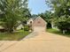 Charming two-story brick home with well-manicured lawn and a long driveway, perfect for Gathering living at 105 Avonwood Cir, Locust Grove, GA 30248
