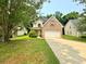 Charming two-story brick home with well-manicured lawn and a long driveway, perfect for Gathering living at 105 Avonwood Cir, Locust Grove, GA 30248