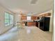 Open kitchen features light-colored cabinets, black appliances, and an eat-in area by the window at 105 Avonwood Cir, Locust Grove, GA 30248
