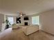 Bright living room featuring neutral walls, carpet, a fireplace, and comfortable seating for relaxing at 105 Avonwood Cir, Locust Grove, GA 30248