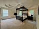 Spacious main bedroom with a tray ceiling, a four-poster bed, and ample natural light at 105 Avonwood Cir, Locust Grove, GA 30248