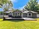 Backyard with a large deck, built in seating, and lush green lawn at 30 Court S, Ellenwood, GA 30294